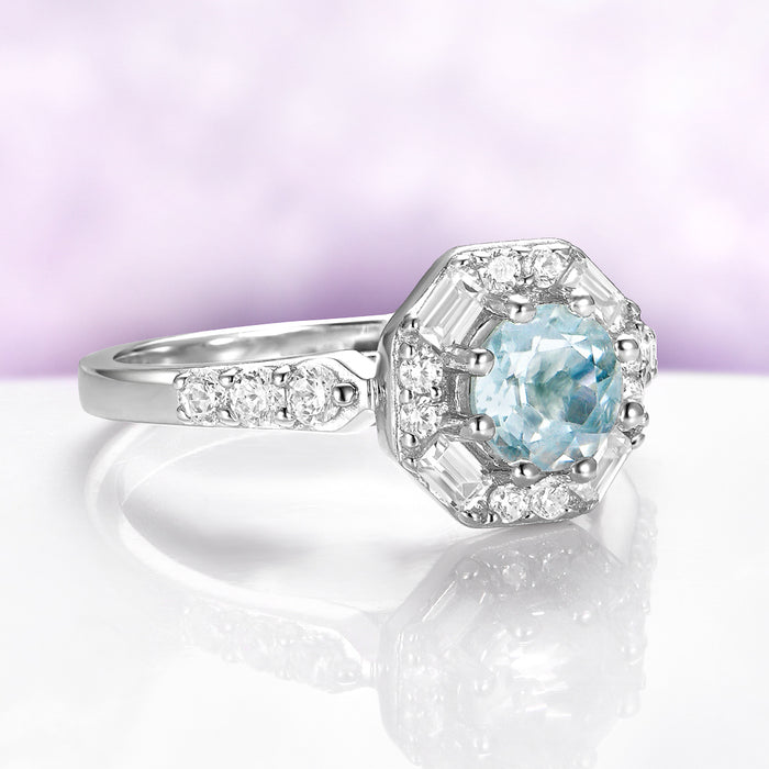 Vintage Octagon Halo Round Aquamarine Ring in Sterling Silver by Aquamarise, featuring a 0.85 carat round aquamarine center with baguette and round simulated diamond halo on a rhodium-finished band.