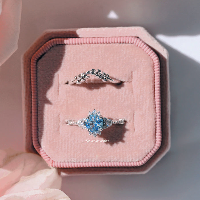 Vintage Round Cut Aquamarine Ring in Sterling Silver displayed with a sterling silver leaf-accented band in a soft pink velvet box by Aquamarise.