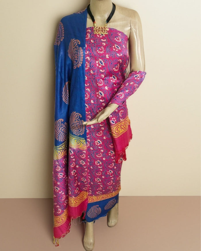 Violet Katan silk unstitched suit set printed in dense fuchsia and blue paisley with small floral sprigs and wide horizontal bands at the dupatta edges