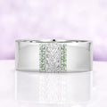 Mens 8mm sterling silver wedding band with a carved leaf panel and green tourmaline channels