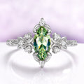 Marquise green tourmaline engagement ring in sterling silver with crescent moons and leaf shoulders