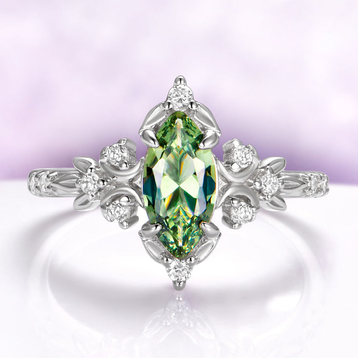 Marquise green tourmaline engagement ring in sterling silver with crescent moons and leaf shoulders