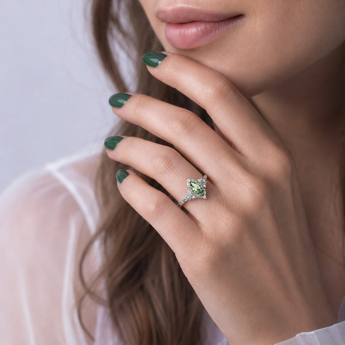 Viridian Marquise Green Tourmaline Engagement Ring by Aquamarise, worn on the hand against a soft white top.