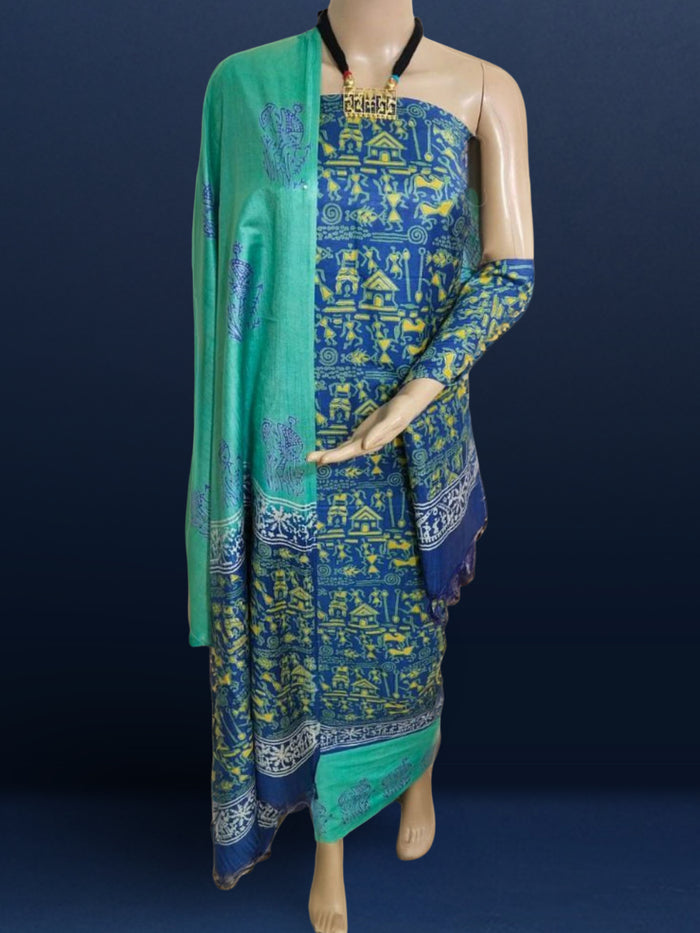 Dark blue Katan silk unstitched suit set hand block printed with small yellow Warli figures, huts and animals in a dense all-over repeat, with a linear motif border band at the hem and light blue accents.