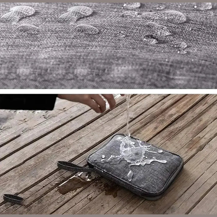Waterproof electronics organizer bag repelling water droplets
