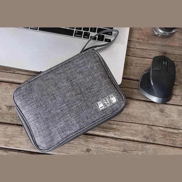 waterproof electronics organizer bag placed near a laptop and mouse