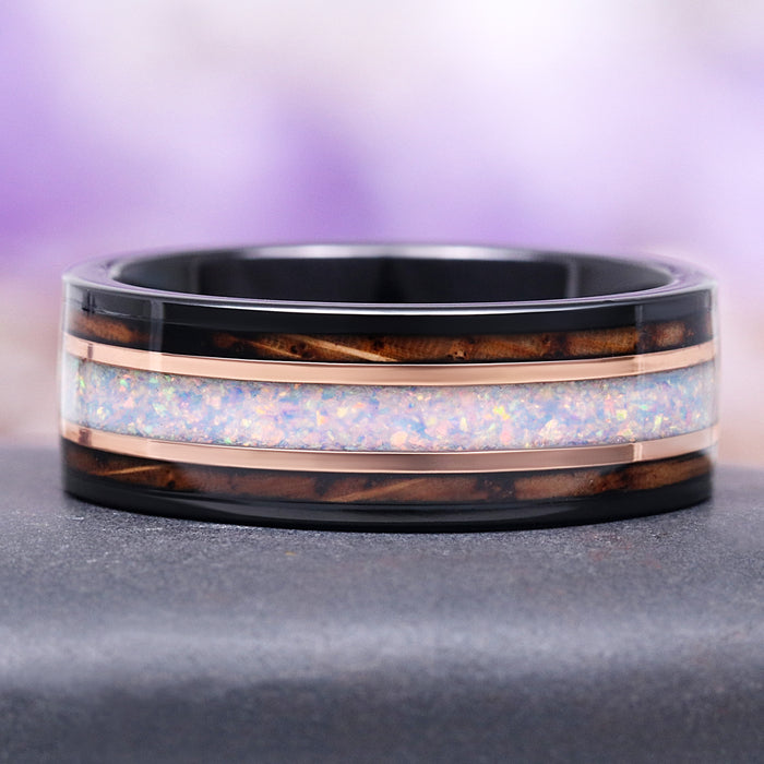 Whiskey Barrel and White Fire Opal Wedding Band in Tungsten (8mm) by Aquamarise features a polished black tungsten band with rich whiskey barrel wood inlays and a dazzling white fire opal center stripe, crafted for men's wedding bands and October birthstone collections.