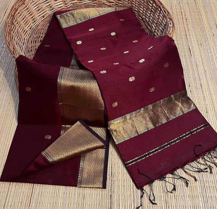 Deep wine red Maheshwari silk saree with small gold buti, a wide gold border and a kuchu-finished pallu, handwoven in Maheshwar