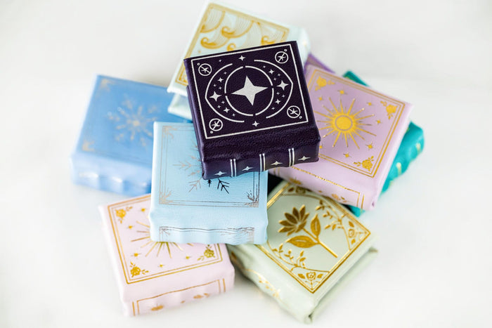 Winter Court Leather Book Ring Box – Frost Sky Edition (Small) by Aquamarise, showcasing a blue leather book-style ring box with celestial gold foil details from handmade ring boxes collection.
