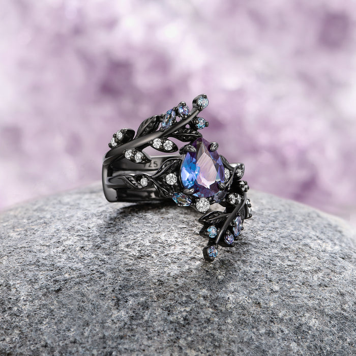Wisteria Alexandrite Fairy Leaf Ring in Black Ruthenium (Two Piece) by Aquamarise features a pear-shaped alexandrite gemstone set in an intricately designed black ruthenium band with delicate leaf and floral motifs, part of June Birthstone Jewelry and Lovers of the Dark™ collections.