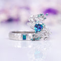 Wisteria Alexandrite Leaf Couples Ring Set by Aquamarise featuring a hammered band with rectangular alexandrite and a matching intricate leaf-inspired ring with a pear-shaped lab-grown alexandrite and detailed green accents, part of Matching Couples' Rings and June Birthstone Jewelry collections.