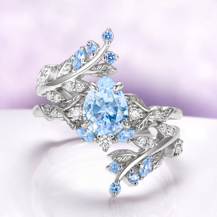 Wisteria Aquamarine Fairy Leaf Ring- 14K White Gold (Two Piece) by Aquamarise Gold, featuring aquamarine center and leaf-inspired white gold band with delicate blue gemstone accents.