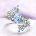Wisteria Aquamarine Fairy Leaf Ring- 14K White Gold (Two Piece) by Aquamarise Gold, featuring aquamarine center and leaf-inspired white gold band with delicate blue gemstone accents.