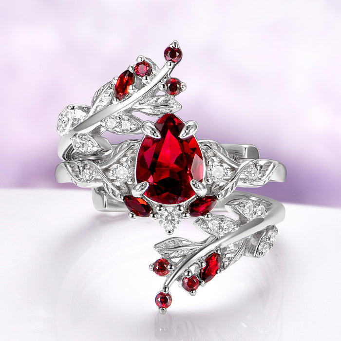 Wisteria Natural Red Garnet Leaf Couples Ring Set by Aquamarise, featuring sterling silver bands with detailed leaf designs and vibrant red garnet gemstones for matching couples rings.