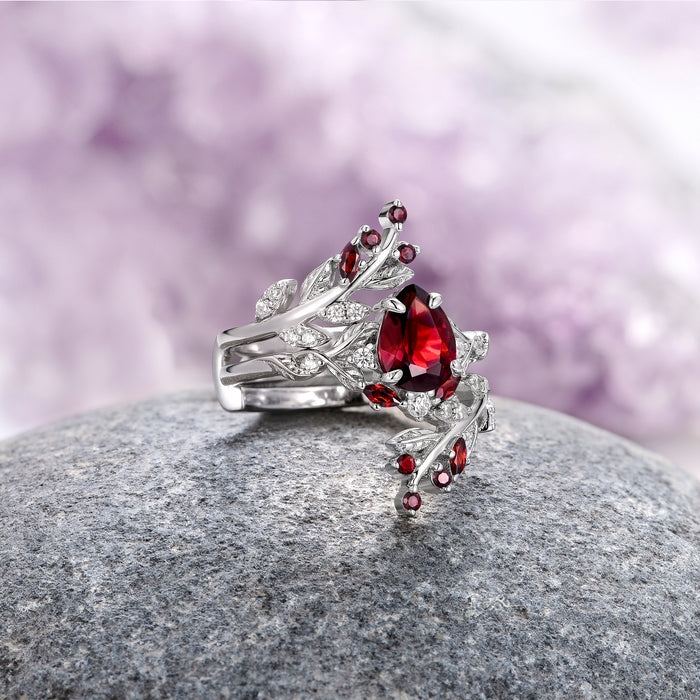 Wisteria Natural Red Garnet Leaf Couples Ring Set by Aquamarise, featuring a sterling silver band with a marquise red garnet centerpiece accented by smaller garnet stones and intricate leaf-inspired details, part of Matching Couples’ Rings and January Birthstone Jewelry collections.