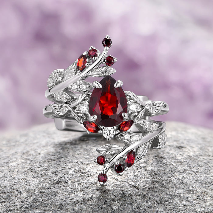 Wisteria Natural Red Garnet Leaf Couples Ring Set by Aquamarise featuring sterling silver bands with nature-inspired leaf motifs, adorned with deep red garnets and sparkling white gemstones, part of Matching Couples’ Rings, January Birthstone Jewelry, and Meaningful Jewelry Gifts collections.